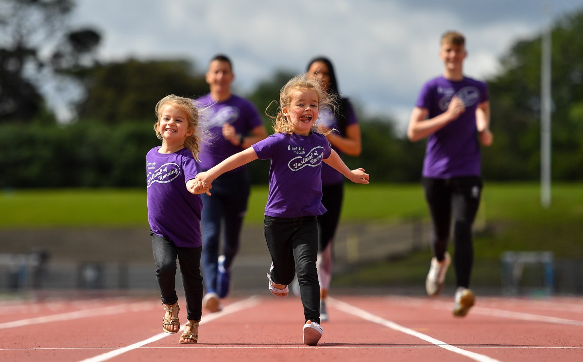 girls holding hands and running