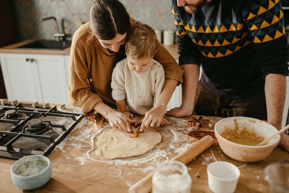 Family baking a cake in their kitchen