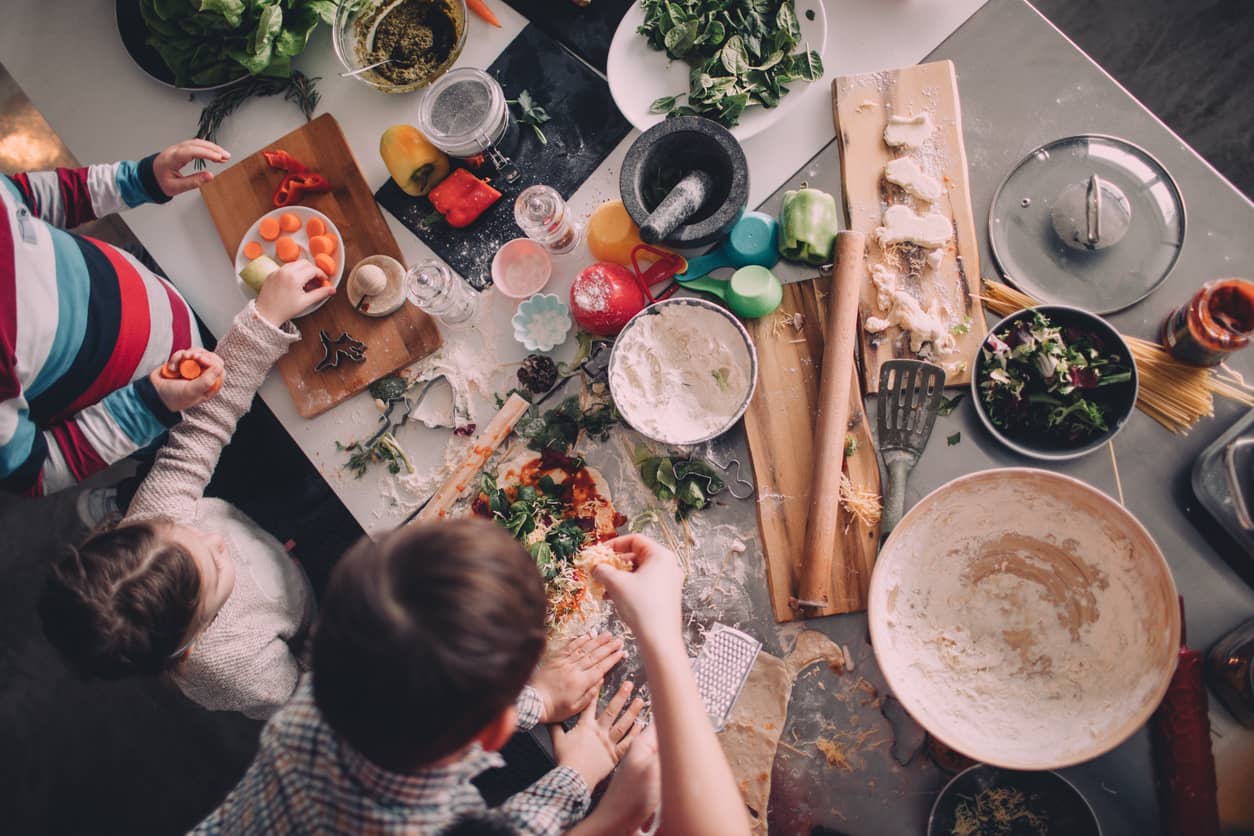 Family preparing dinner in kitchen