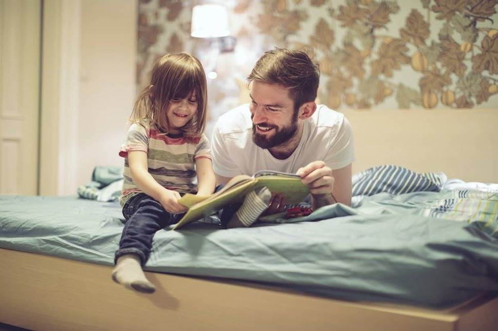 Father reading to his daughter