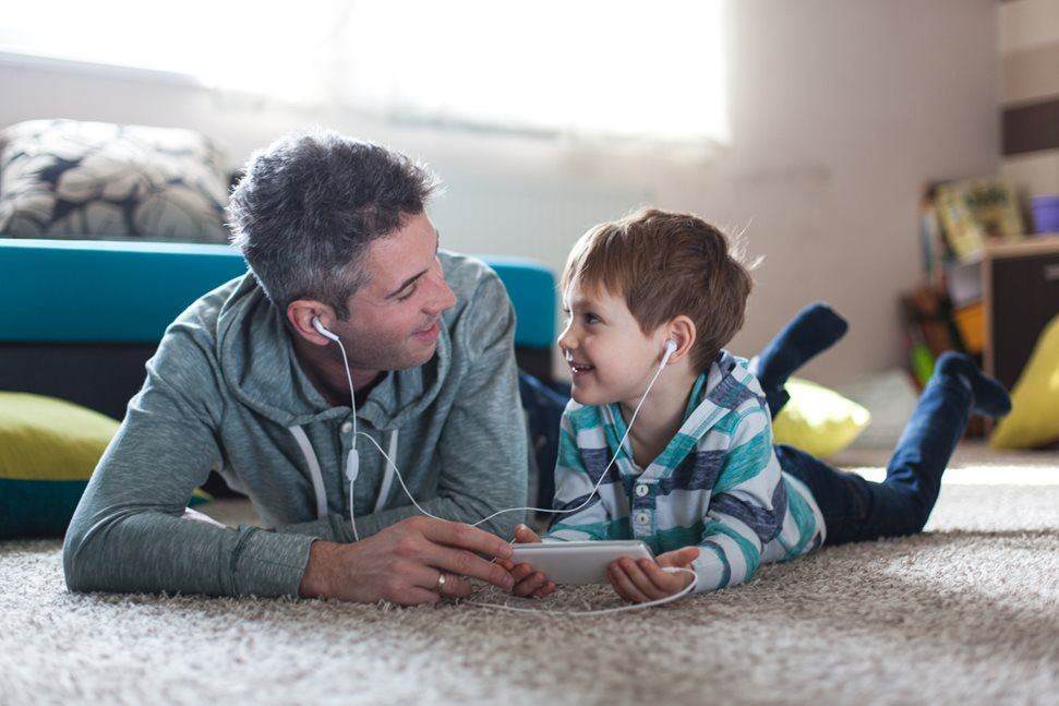 Father and son listening to music