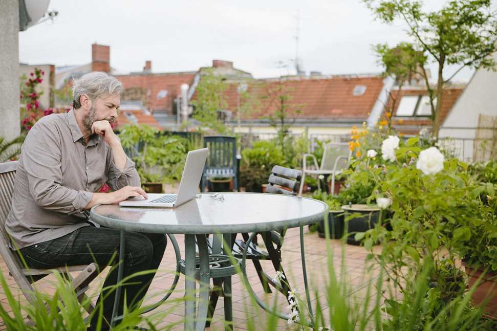 Man on laptop in garden