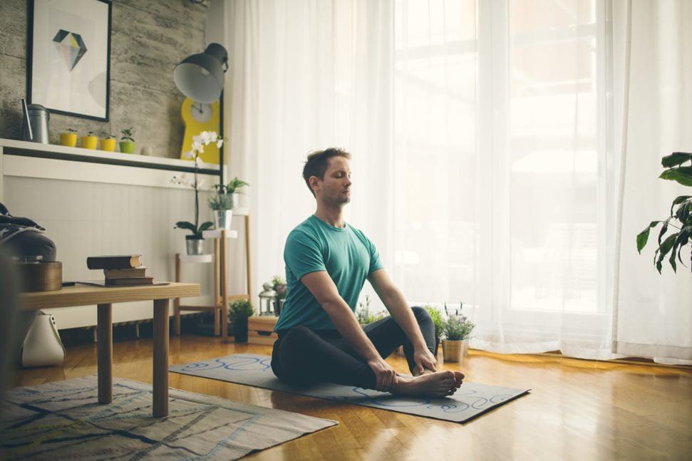 Man doing yoga at home