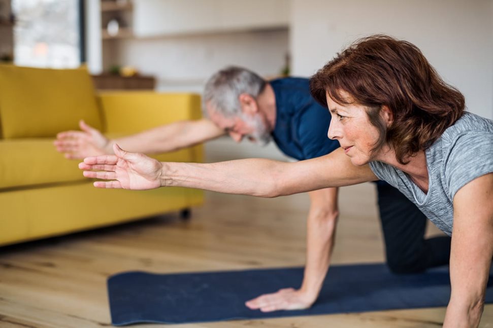 Older couple exercising from home