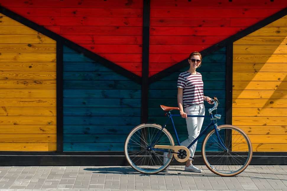 Woman standing with bike outside