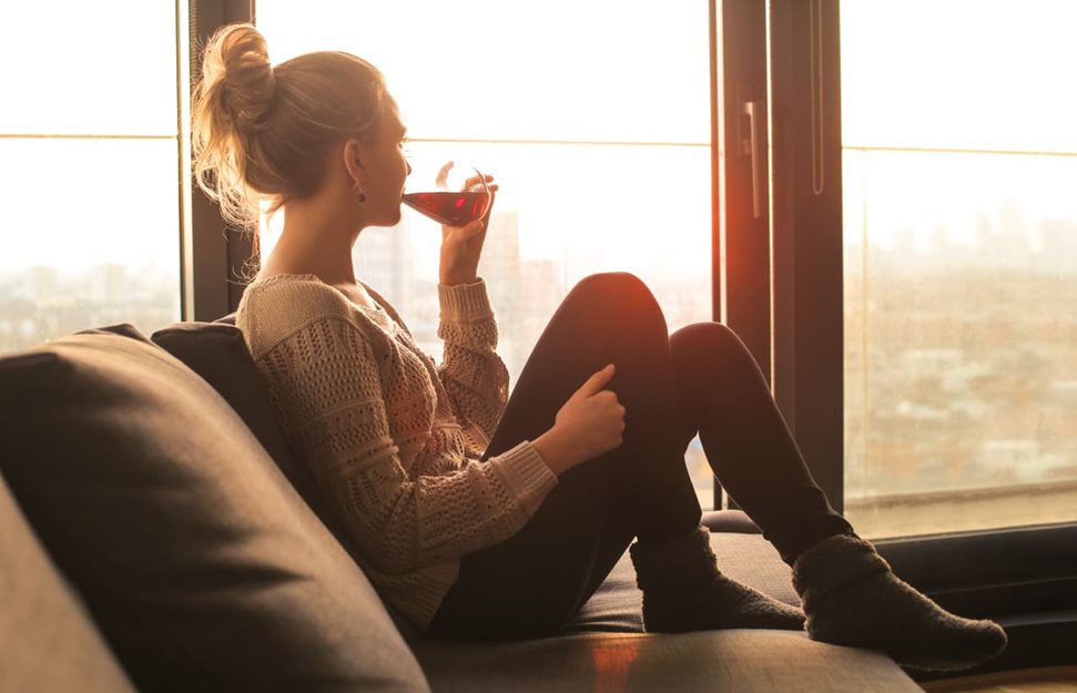 Woman drinking wine at home