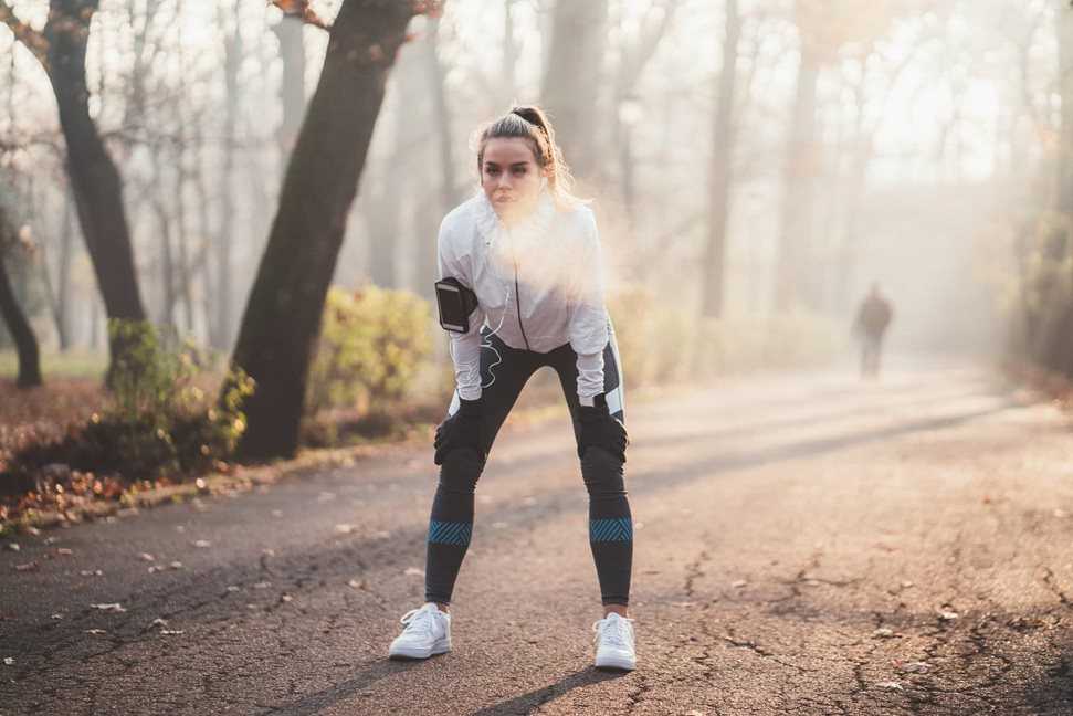 Woman stopping for a break from running