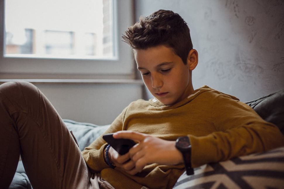 Boy on his mobile phone