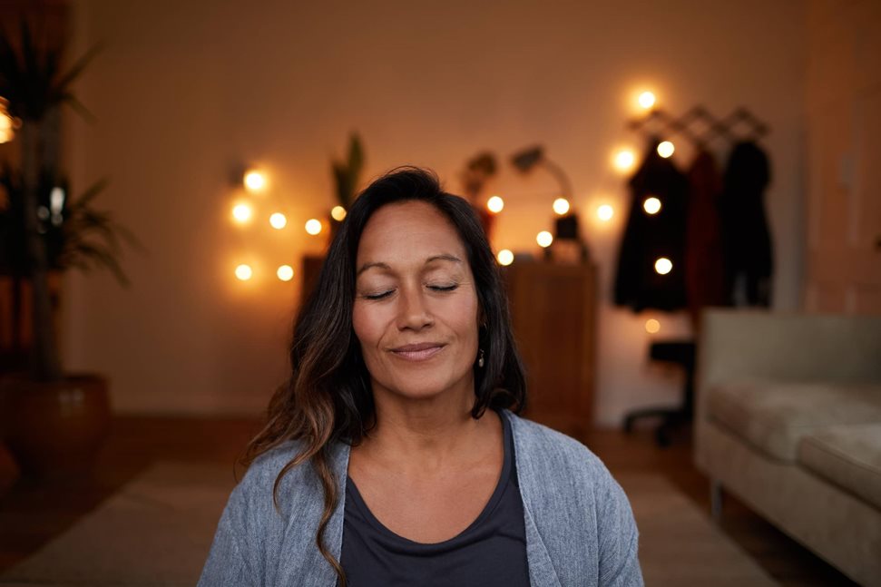 Woman meditating in her sitting room