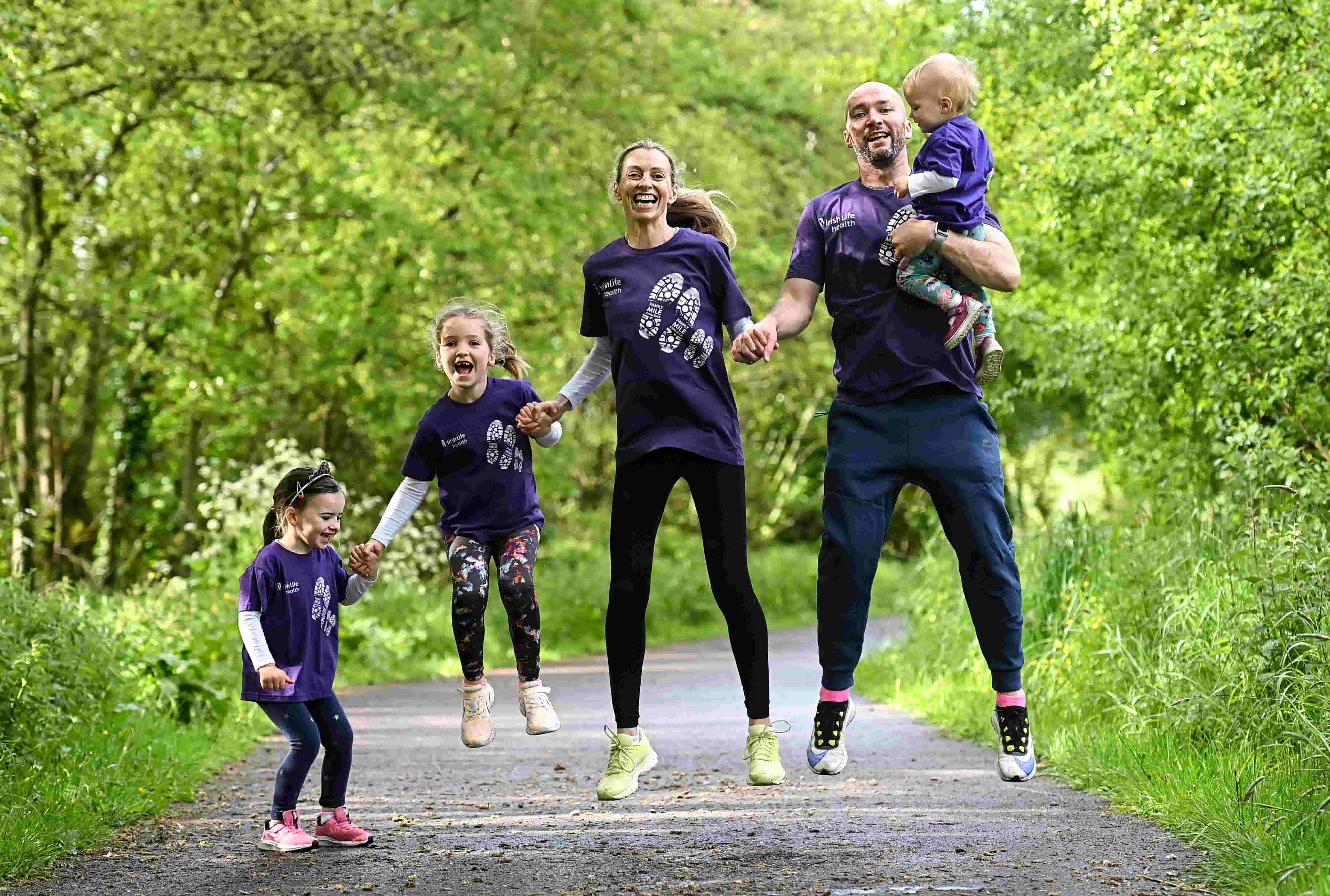 Lizzie Lee jumping for joy with her family