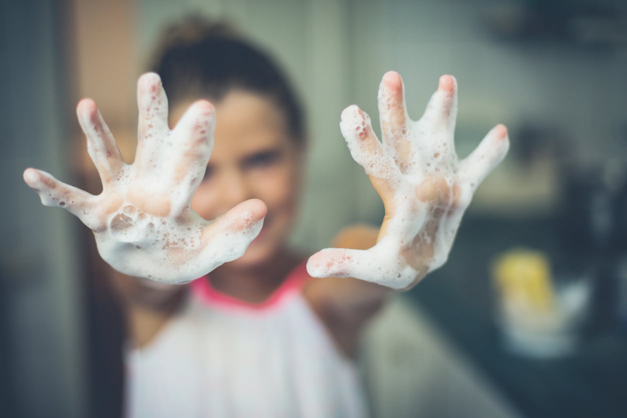 Woman washing hands with suddy water