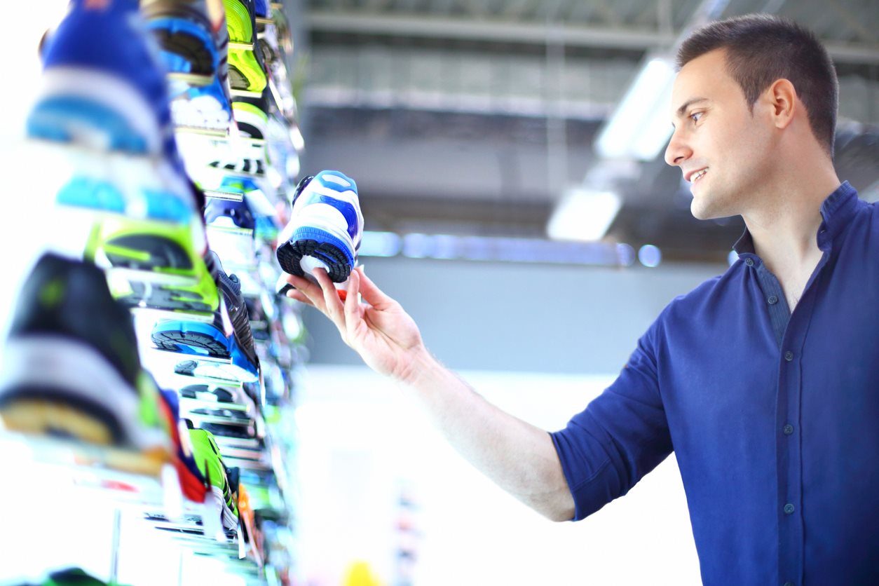 man shopping for running shoe