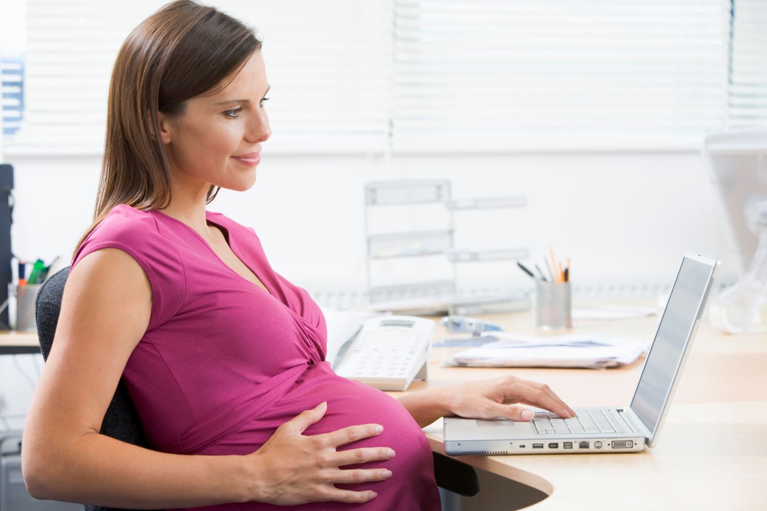 pregnant woman at desk