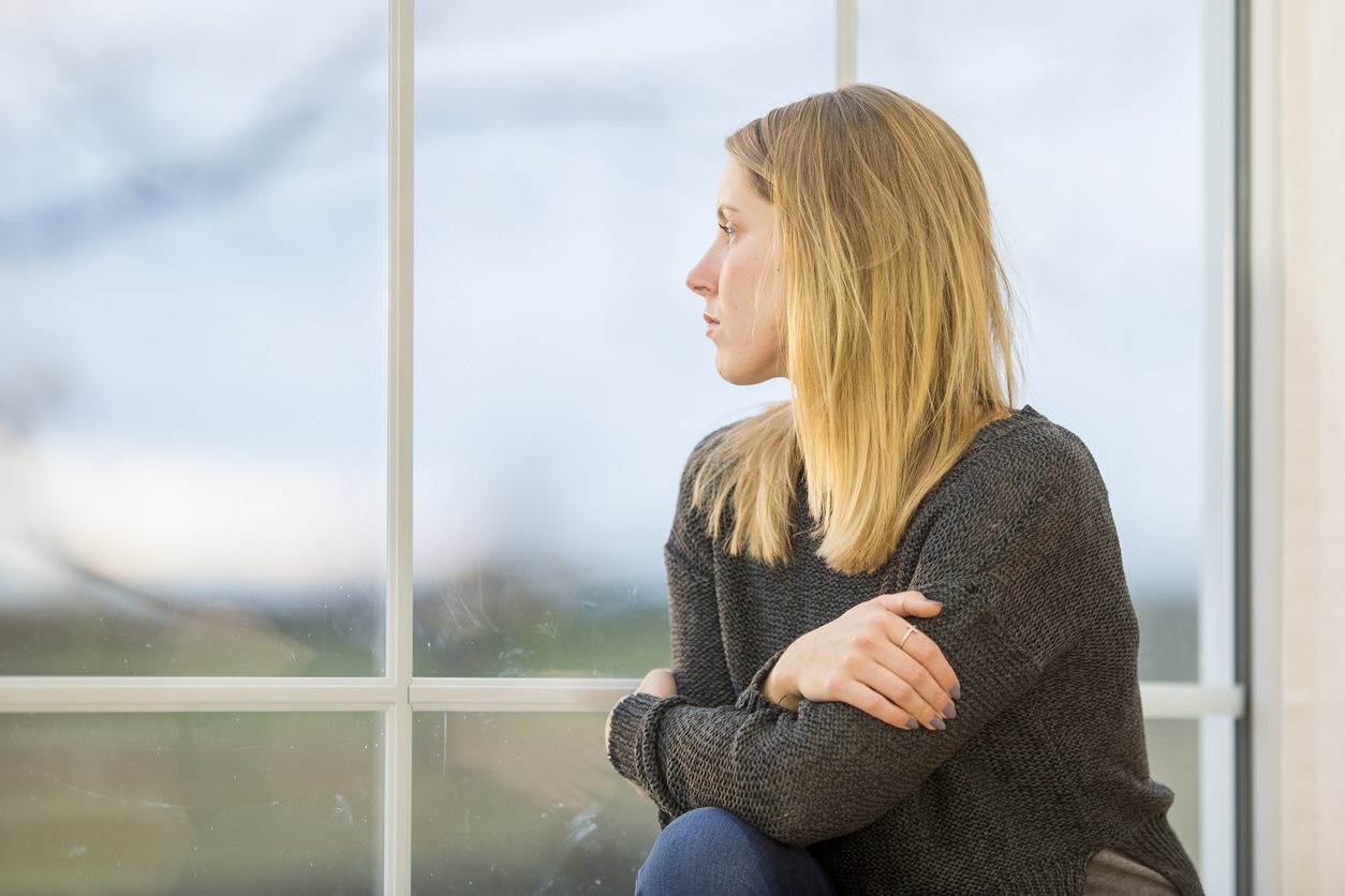 sad woman at window