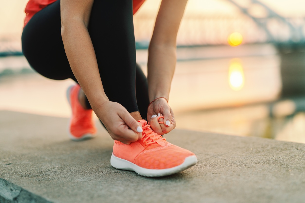 woman tying running shoe