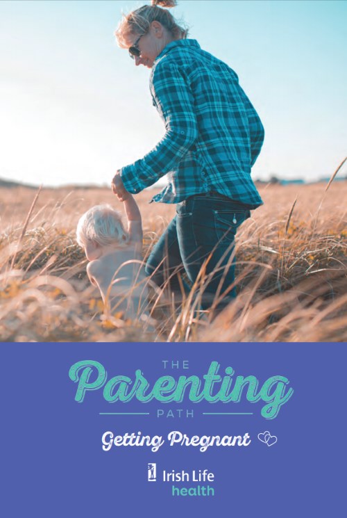 Mother and child walking through field