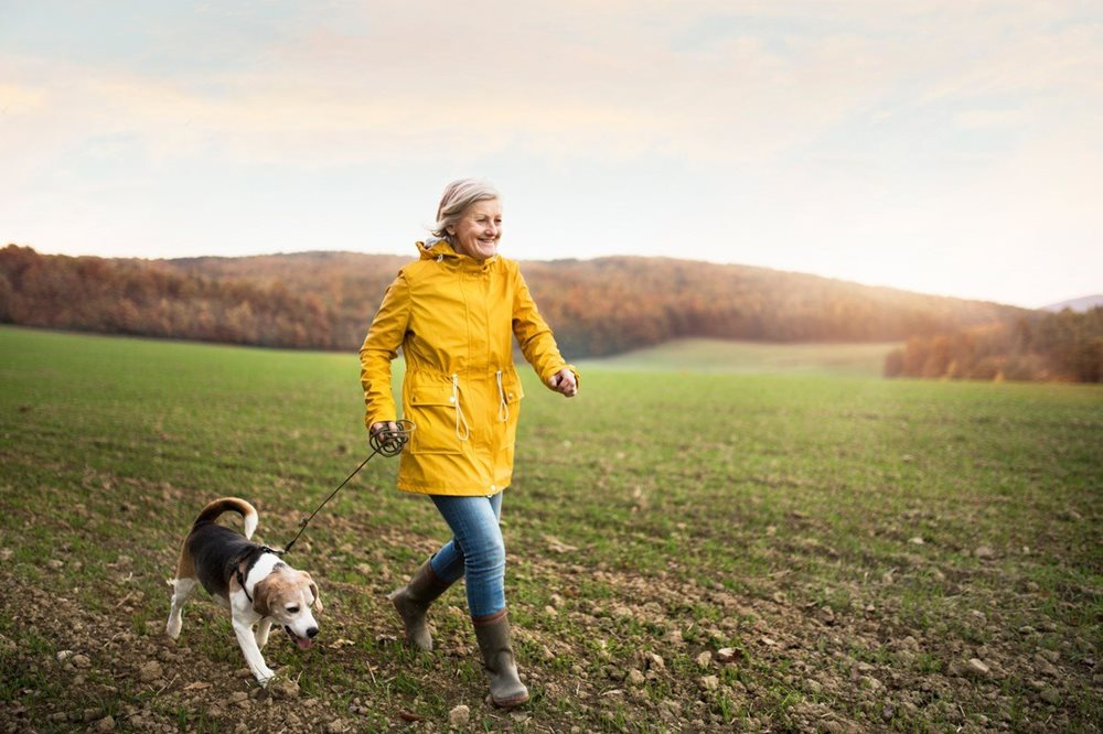 woman walking dog in park
