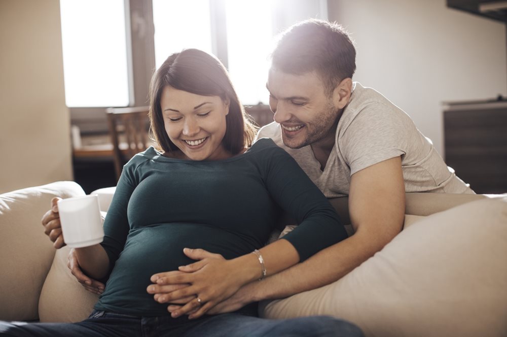 pregnant couple on couch
