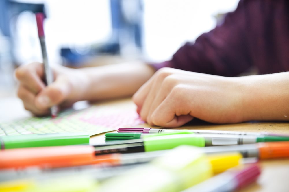 Child drawing with coloured pen