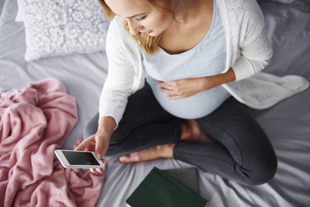 pregnant woman using phone