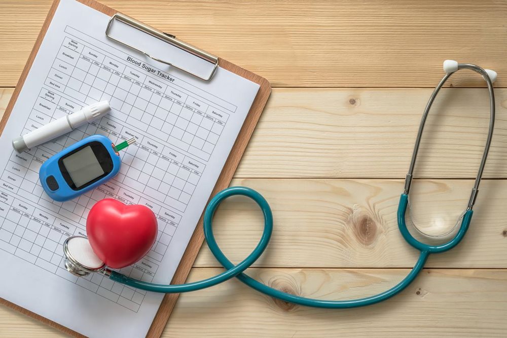 Stethoscope and patient chart on table