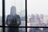 Silhouette of woman looking out of window