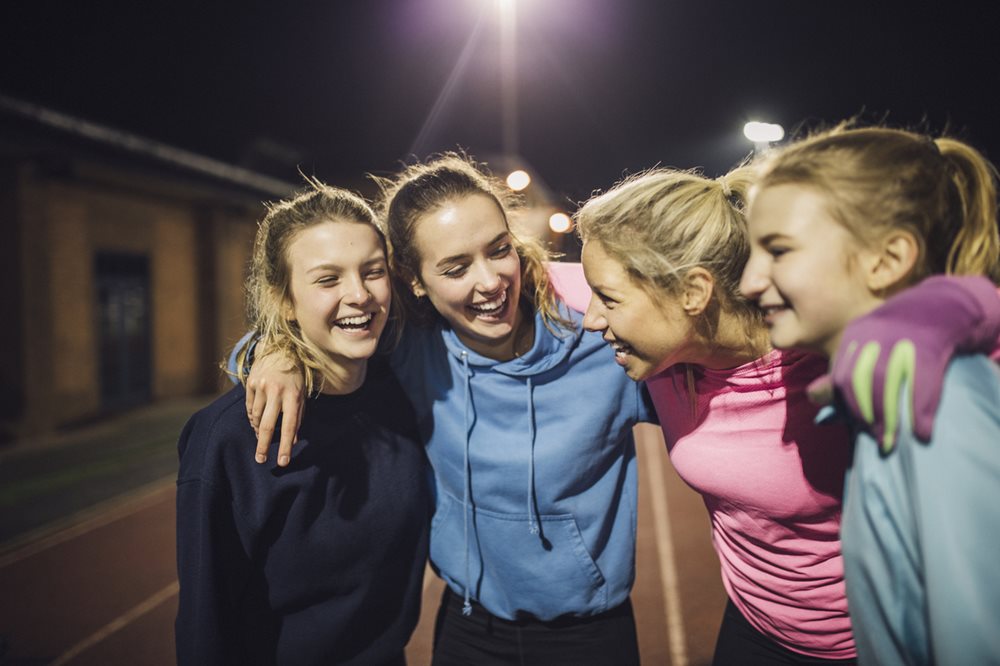 Group of girls hugging and laughing