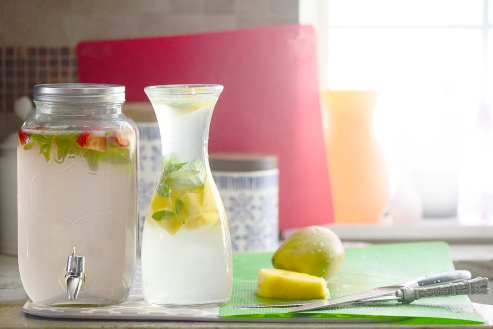 water and fruit in jugs