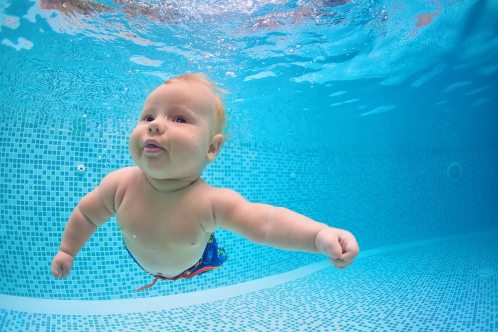 Baby swimming underwater in pool