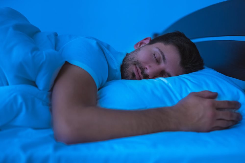 Man with smile on his face having a relaxing sleep